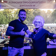 DJ i prowadzący na scenie, w dali tłum seniorów